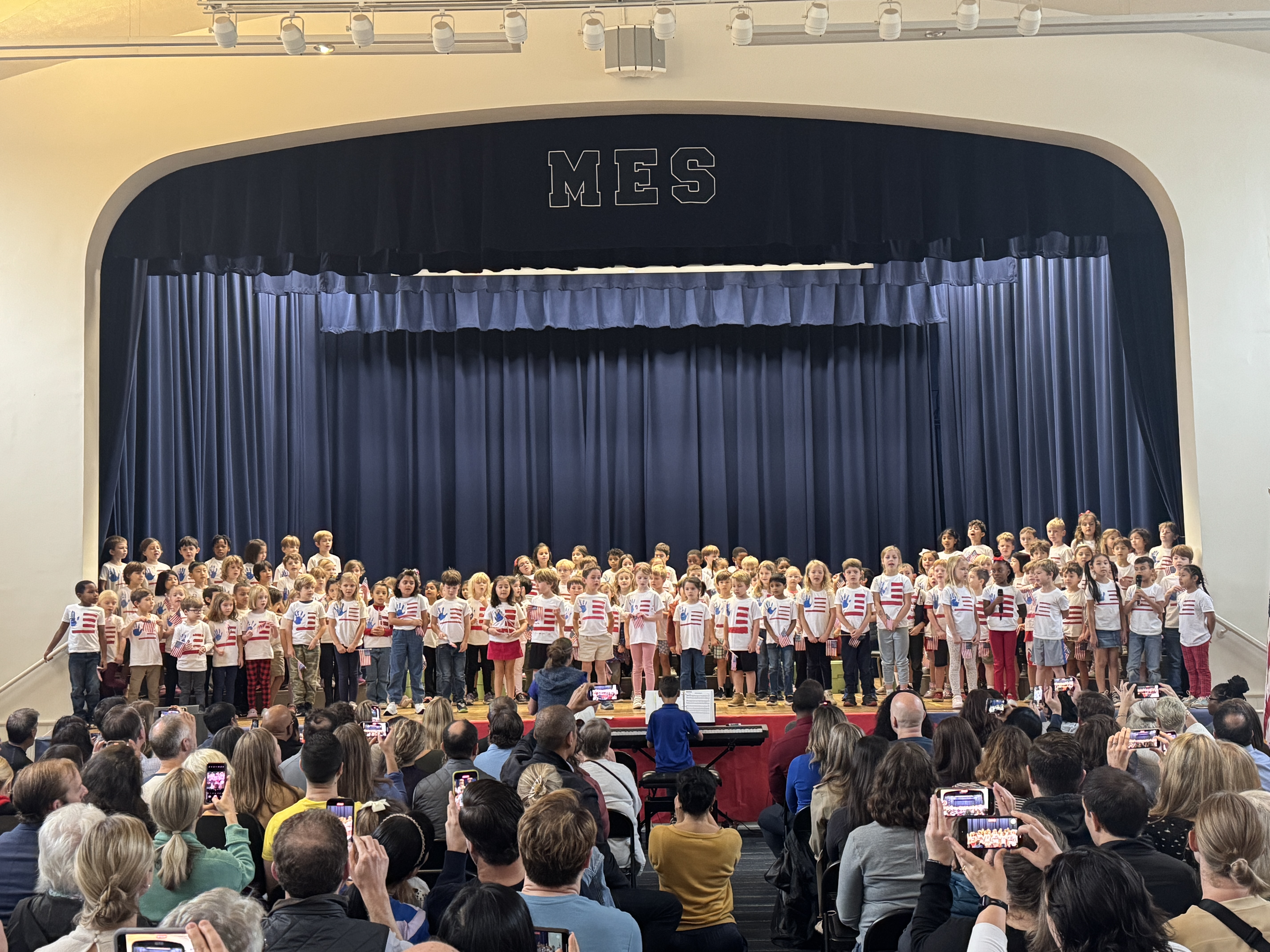 A group of children on a stageDescription automatically generated